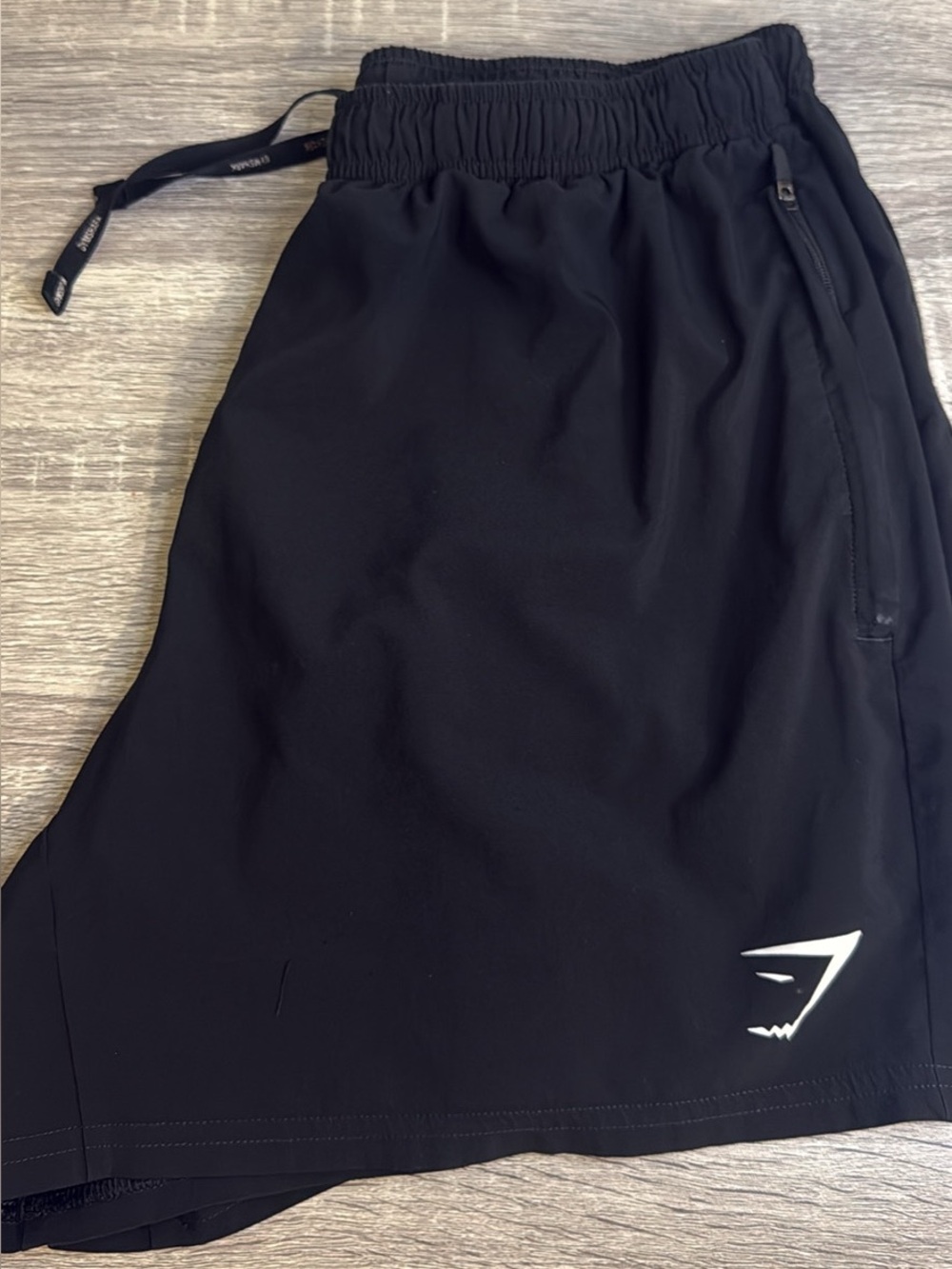 Gymshark womens Black Athletic Training Shorts with White Logo has pockets